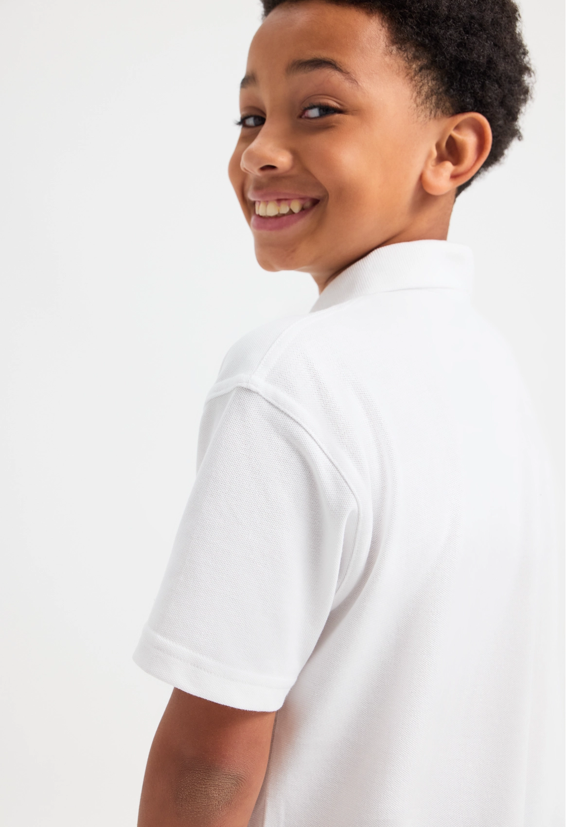 Model wearing Uneek UC103 Childrens Classic Poloshirt