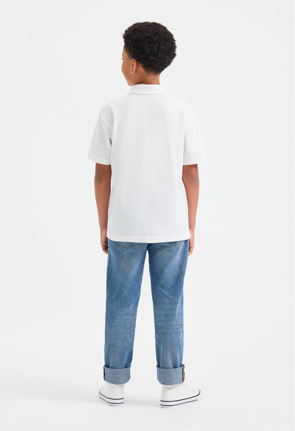 Model wearing Uneek UC103 Childrens Classic Poloshirt