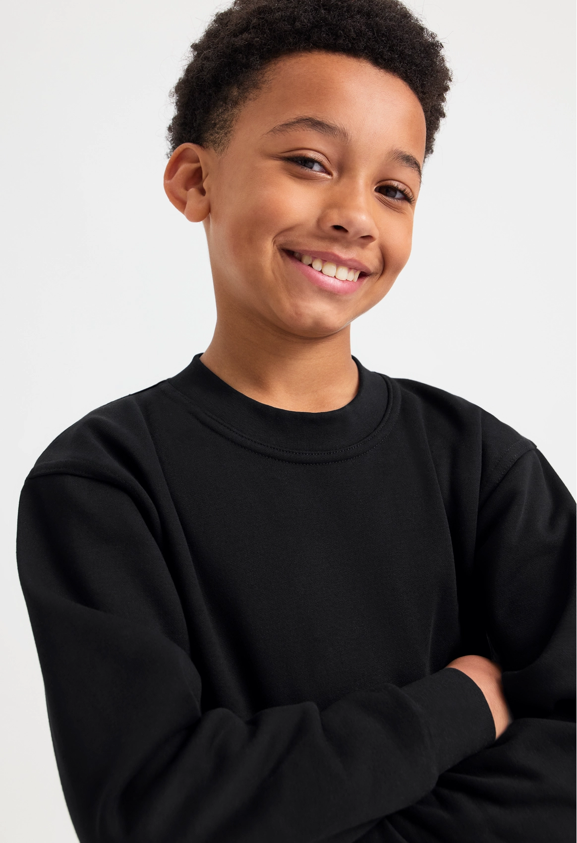 Model wearing Uneek UC202 Childrens Classic Sweatshirt