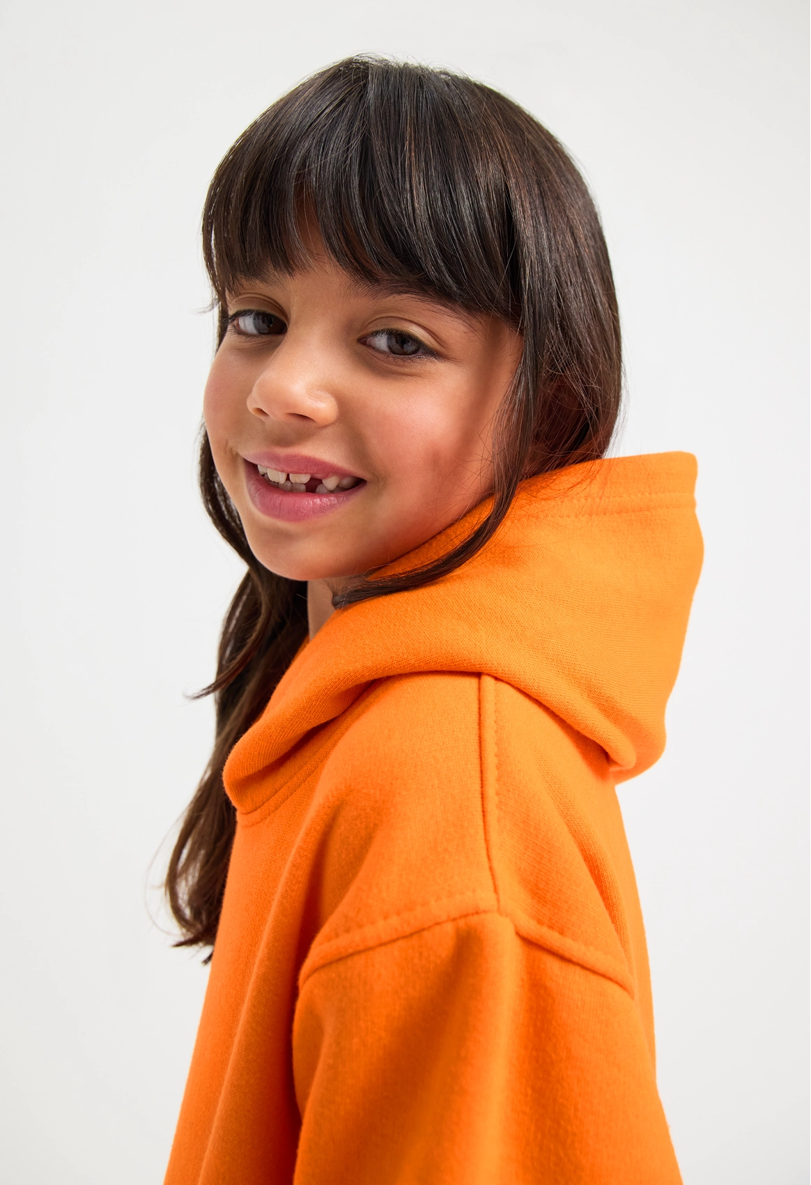 Model wearing Uneek UC503 Childrens Classic Hooded Sweatshirt