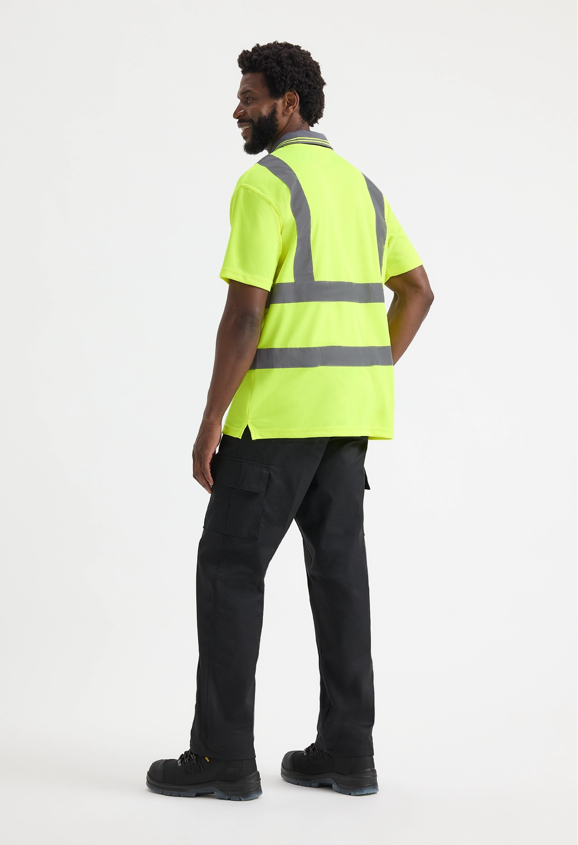 Model wearing Uneek UC808 Hi Vis Short Sleeve Polo Shirt